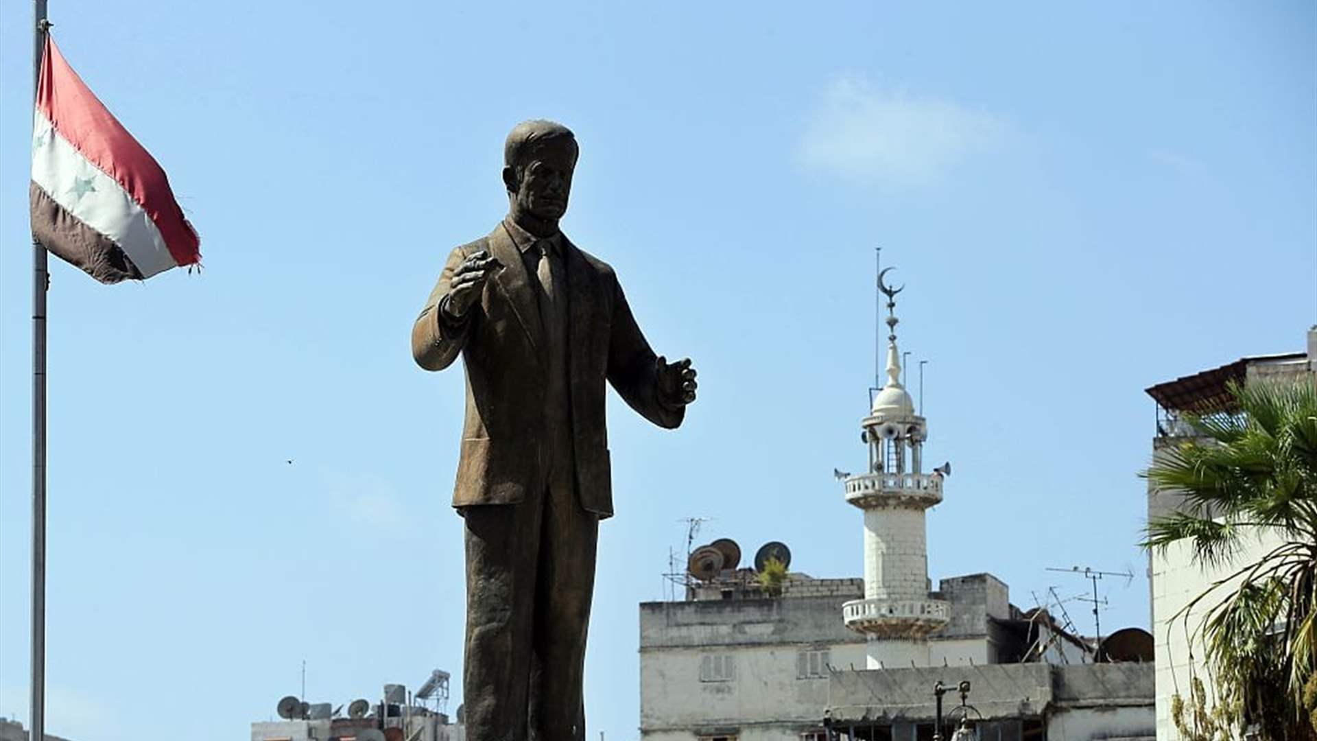 Protesters topple statue of Assad&#39;s father in Damascus suburb: Witnesses tell AFP