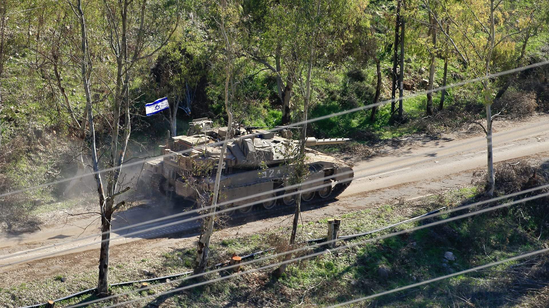 Israeli bulldozers conduct excavation work in southern Lebanon under tank protection