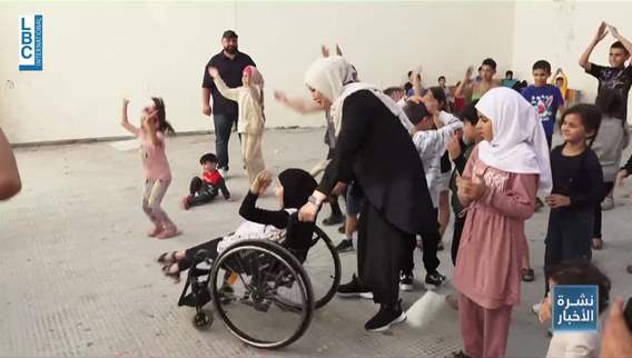 Displaced people gather at shelter centers, creating a joyful atmosphere